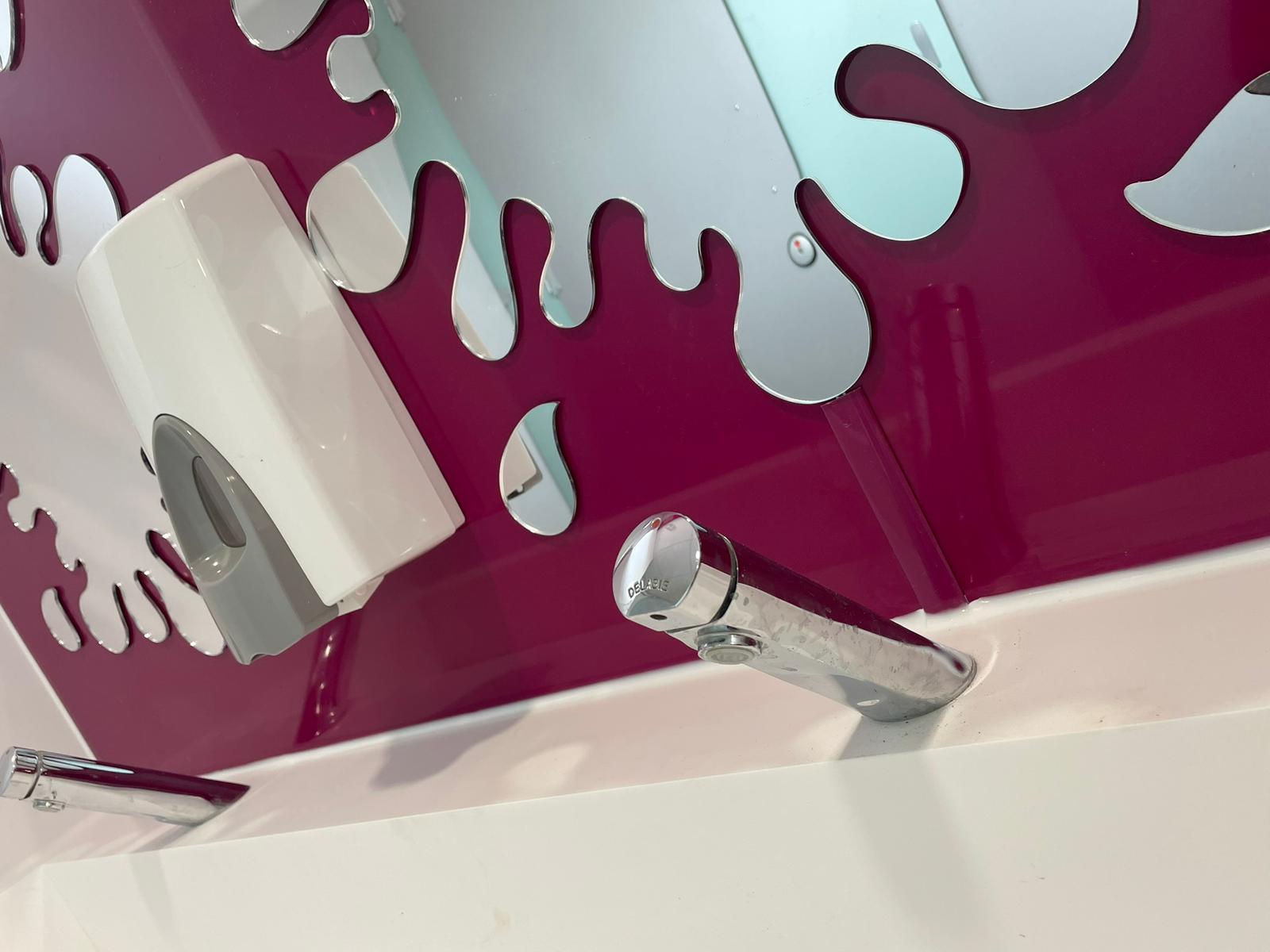 close up of tap and splash mirror